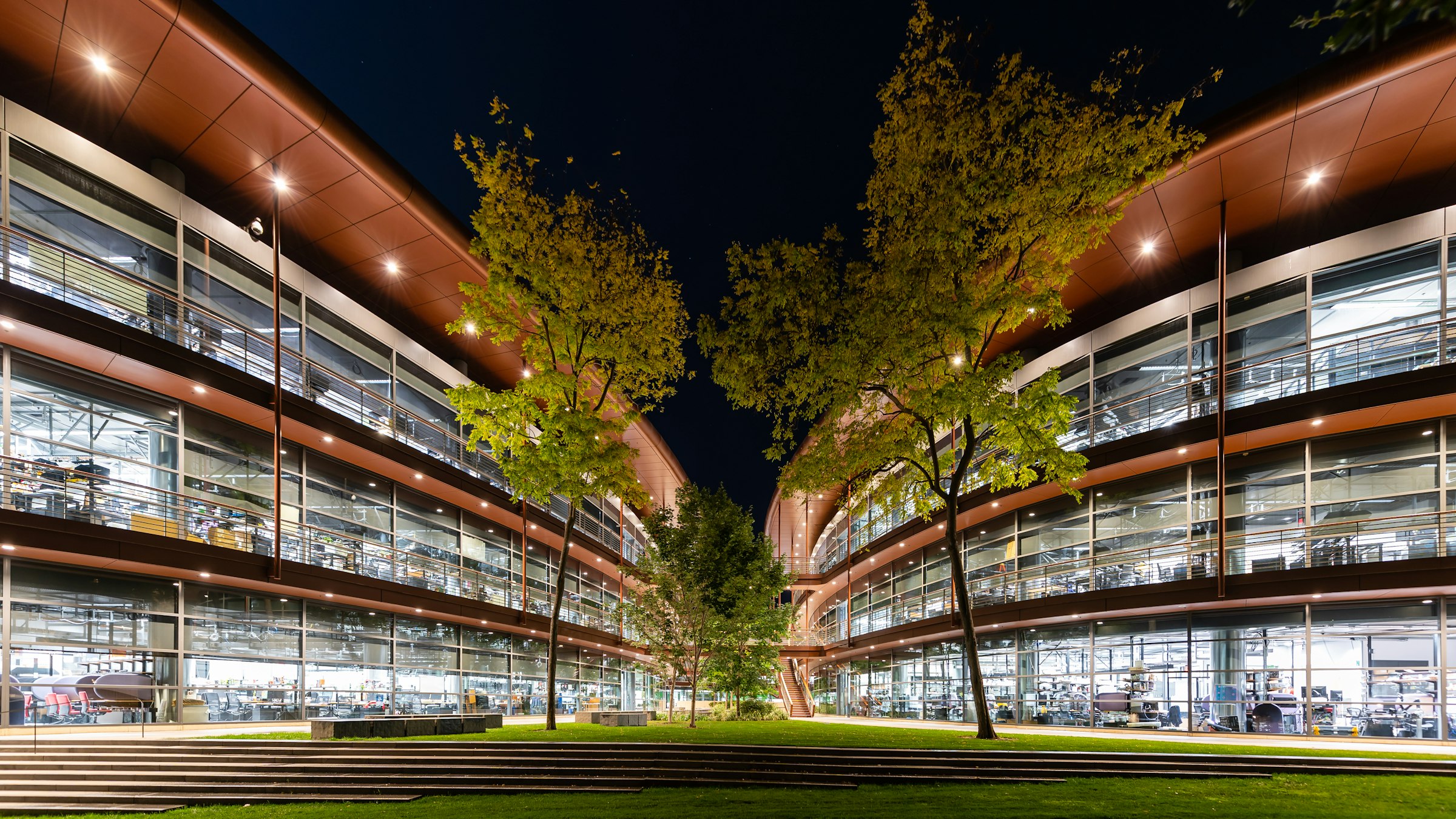 Modern research-building facade with transparent glazing — symbolising the open academic and industrial network that supports Elysée's innovation programme.