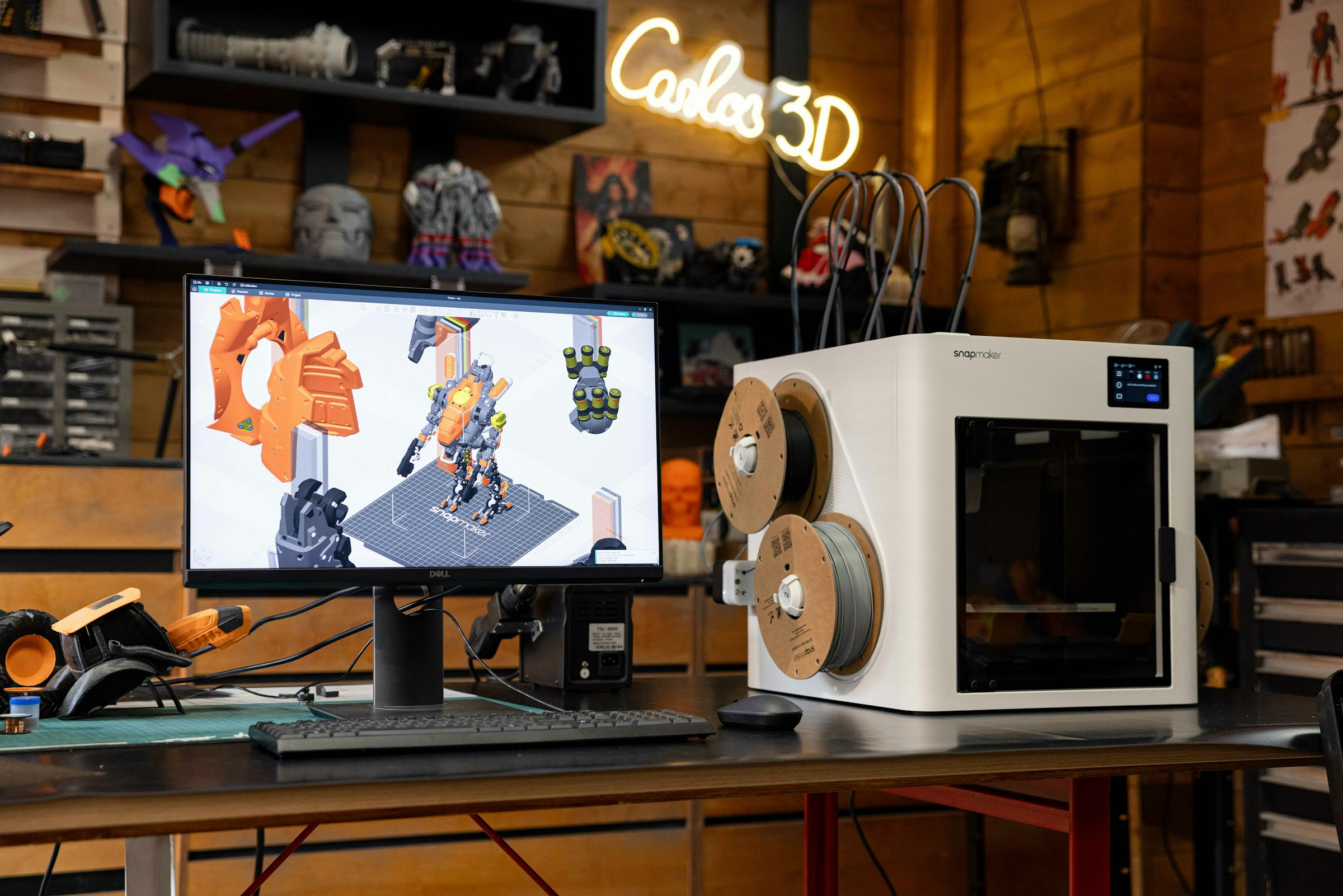 Additive manufacturing in progress — a 3D printer running alongside an on-screen CAD model, illustrating Elysée's prototyping and concept-development workflow.